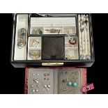Jewellery box with many pieces of silver jewellery.