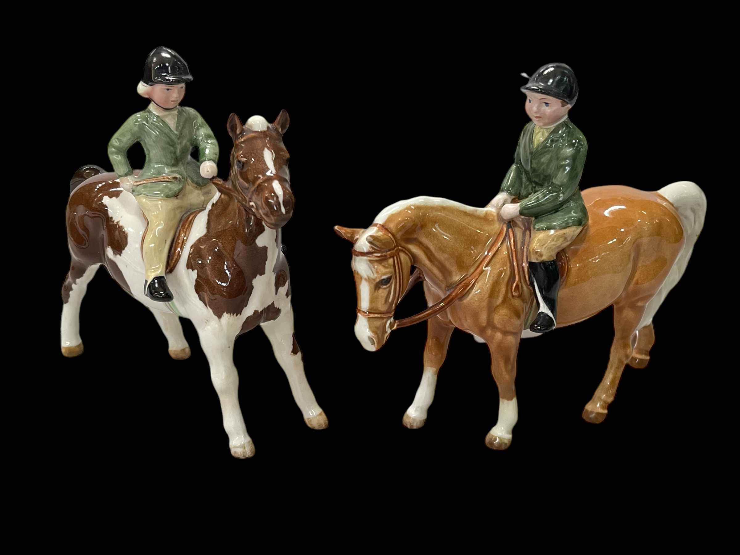 Two Beswick ponies with riders.
