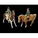 Two Beswick ponies with riders.