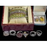 Jewellery including six silver gem set rings, matching ring and pendant, and colourful bracelets.