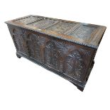 Antique carved oak four panel front coffer, 68cm by 128cm by 53cm.