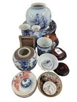 Collection of Oriental china including vases, dish, mug, wood vase stands, etc.
