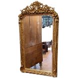 Gilt framed bevelled overmantel mirror with cherub and foliate crest, 152cm by 84cm.