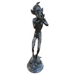 Ornate bronzed Pixie blowing a conch shell, 84cm.