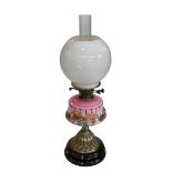 Victorian oil lamp with pink glass floral reservoir, 61cm.