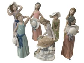 Collection of seven Lladro figures of ladies with bonnets.