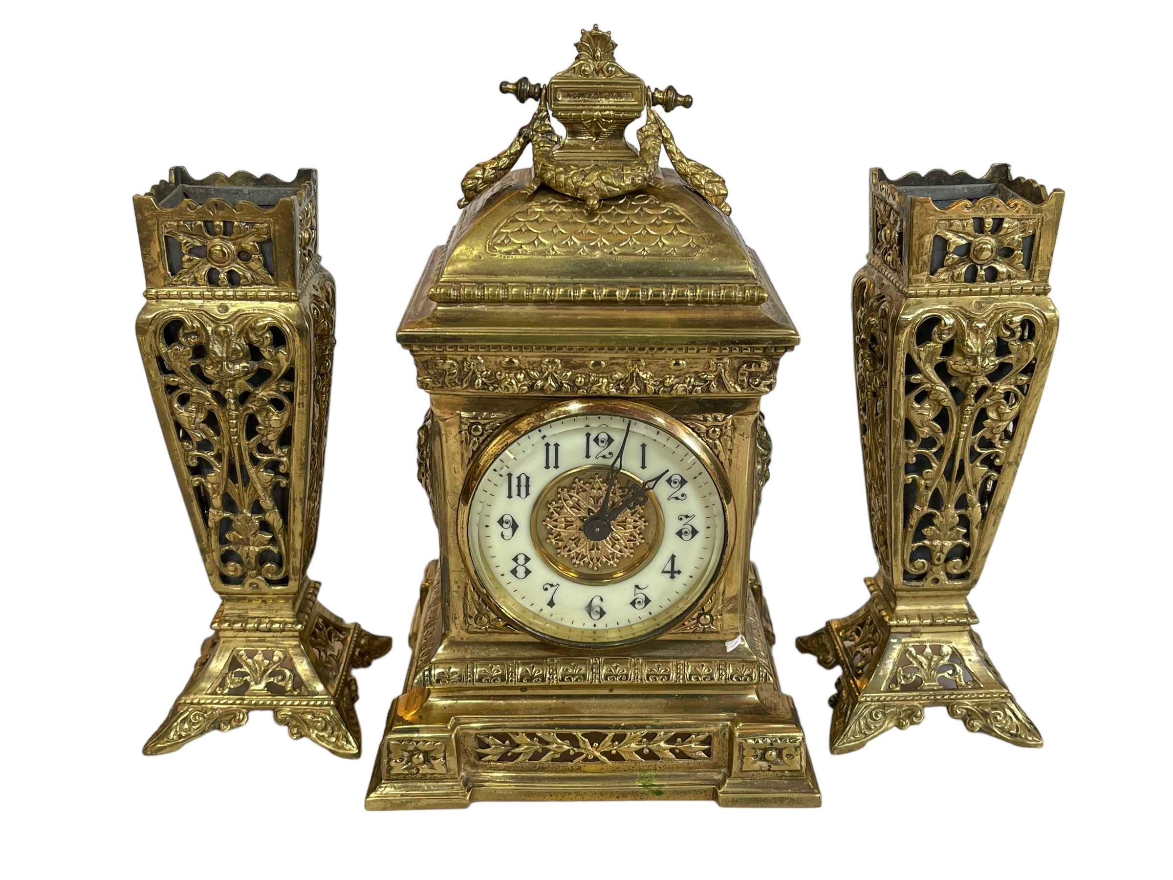 Ornate brass clock garniture set.