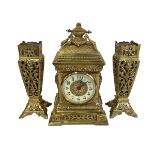 Ornate brass clock garniture set.