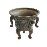 Antique Chinese/Eastern bronze three footed vase decorated with elephant and floral design, 24cm.