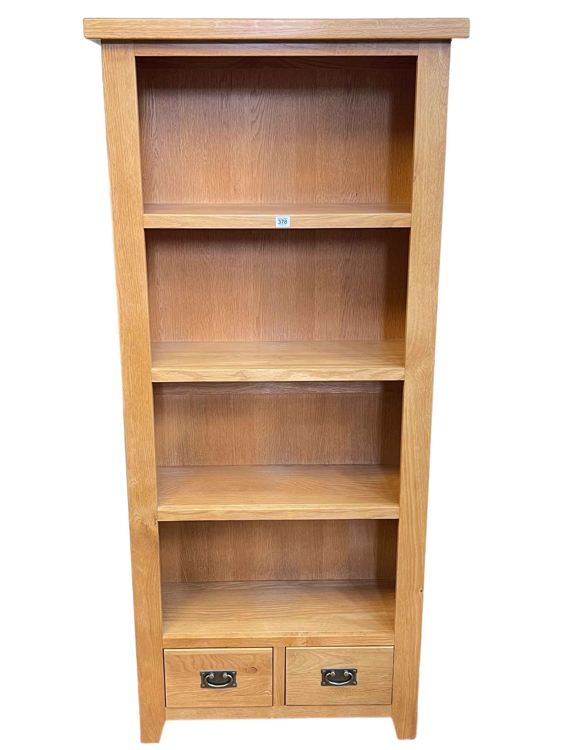 Contemporary light oak open bookcase with two base drawers, 181cm by 80cm by 32.5cm.