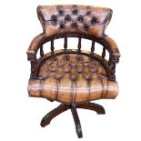 Brown buttoned leather Captains style swivel desk chair.