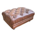 Tan leather deep buttoned footstool, 39cm by 82cm by 60cm.