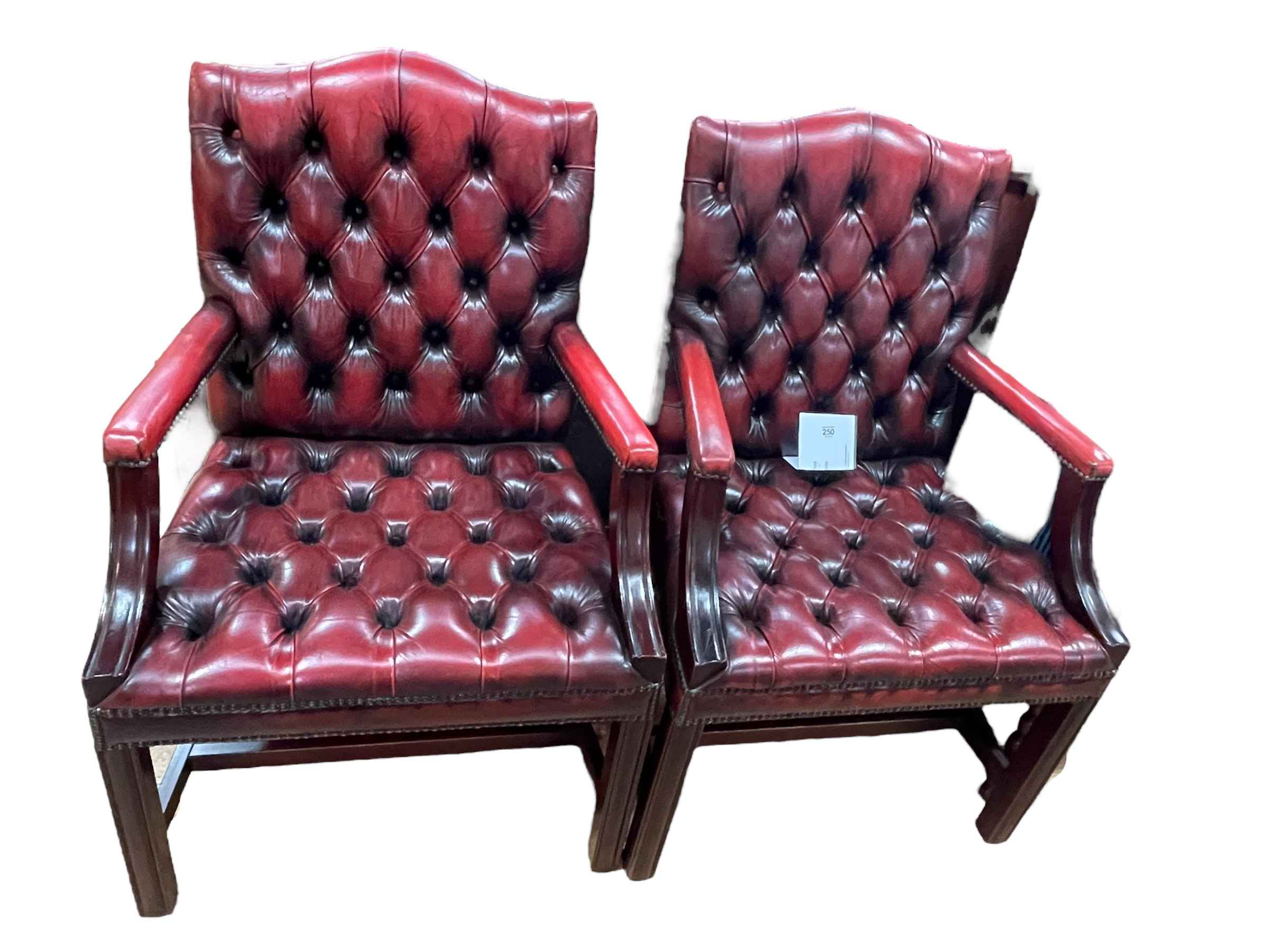 Pair ox blood deep buttoned leather and studded Gainsborough armchairs.