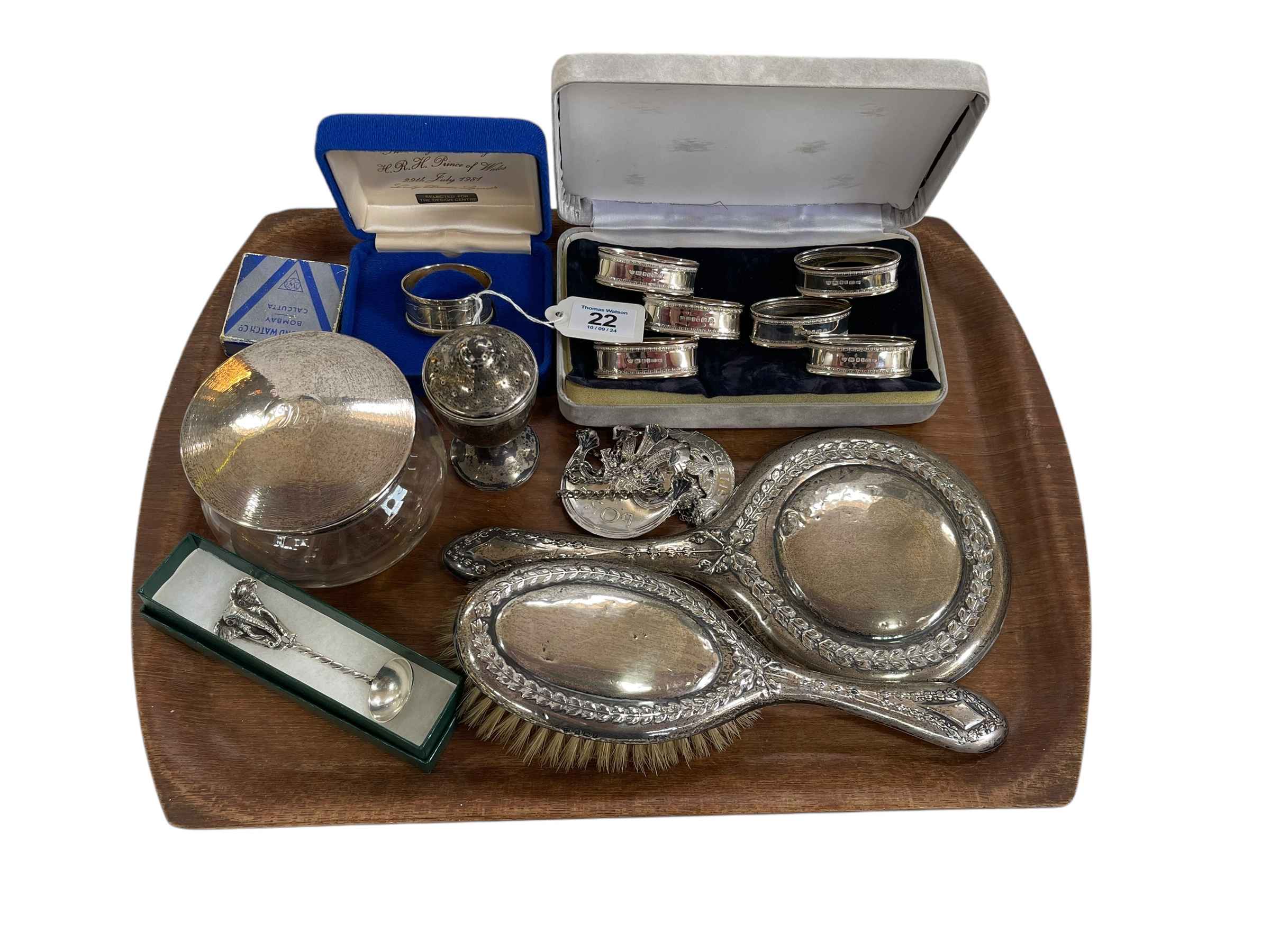 Silver napkin rings, silver backed brush and mirror, silver topped powder bowl, decanter, labels,