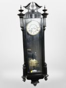 An ebonised Vienna style wall clock with enamelled dial,