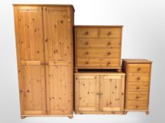 A contemporary pine door wardrobe, five drawer chest,