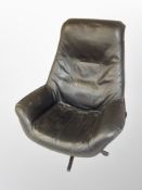 A late 20th century black leather swivel armchair