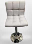 A contemporary rise and fall swivel stool on chrome support