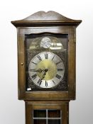 An oak and leaded glass Tempus Fugit longcase clock with pendulum and weights,