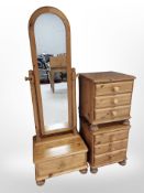 A pair of pine three drawer bedside chests and matching cheval mirror