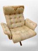 A late 20th century Danish buttoned tan leather swivel armchair (Af)