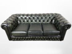 A green buttoned Chesterfield three seater settee,