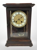 An eight day mantel clock with enamel dial,