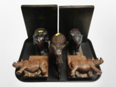 A pair of carved wooden Rhino book ends,