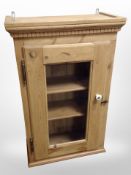 An early 20th century pine single door wall cabinet,