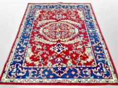 A machine made rug of Persian design,