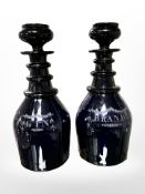 A pair of Regency Bristol blue glass decanters marked Gin and Brandy,