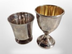 A silver egg cup and one other