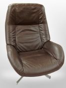 A late 20th Danish brown leather swivel armchair on chrome support