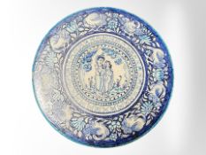 A large 19th century Persian glazed blue and white earthenware charger depicting Sita and Rama,