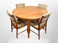 A G-Plan teak circular extending dining table and a set of four chairs