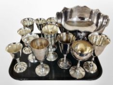 A silver plated punch bowl with lion mask handles and a quantity of goblets