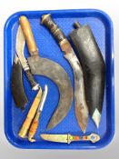 Two Kukri knives in sheaths together with a sickle,