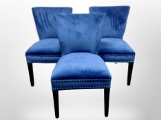 A set of three contemporary chairs in studded blue fabric