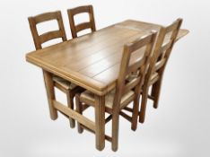 A contemporary oak pull out extending dining table, length 214 cm extended,