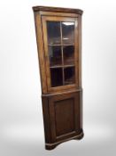 A 19th century stained oak glazed corner cabinet,