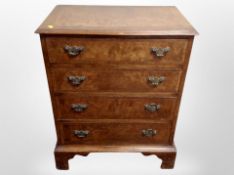A Georgian style burr walnut four drawer chest,