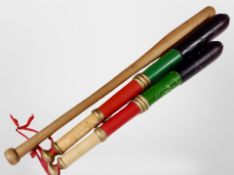 Two painted pine batons and a further baseball bat