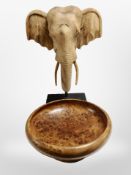 A turned burr walnut pedestal fruit bowl together with a carved elephant head on plinth