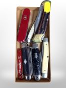 A group of folding pocket knives,
