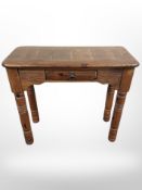 A contemporary pine hall table fitted a drawer,