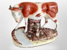 An early 19th century Staffordshire figure of a cow,