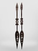 A pair of West African carved wooden dance paddles,