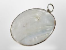 A mother of pearl pendant, 49mm by 39mm.