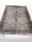 A machine made rug of Persian design 252 cm x 171 cm
