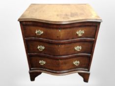 A George III style walnut serpentine three drawer bachelors chest,